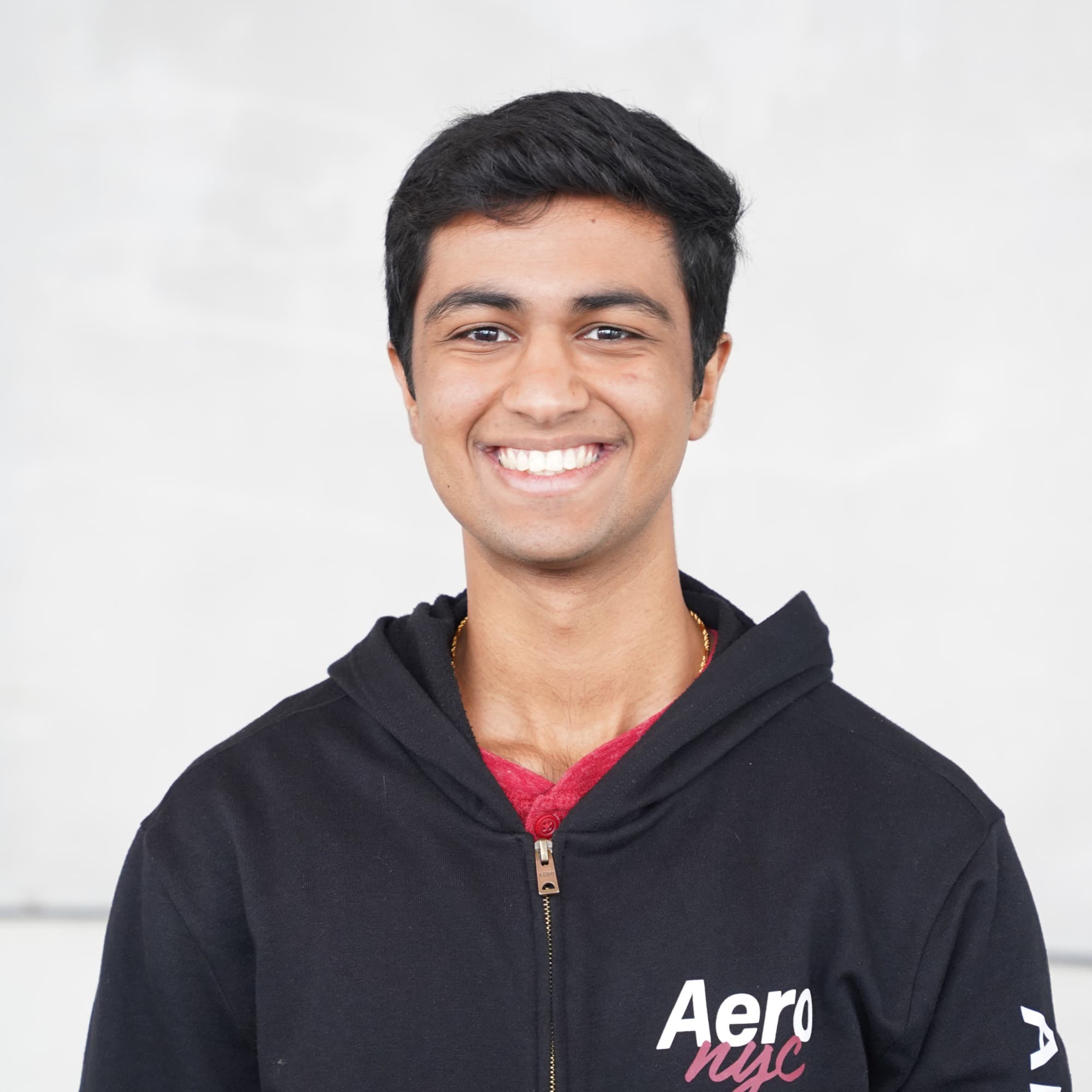 Archit Mehta smiling, wearing a black hoodie.